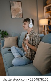 one teenager man young caucasian male use headphones for online guided meditation practice mindfulness yoga with eyes closed at home real people self care manifestation concept copy space generation Z - Shutterstock ID 2364878155