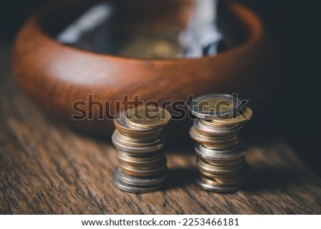 One tenth or tithe is basis on which Bible teaches us to give one tenth of first fruit to God. coins with Holy Bible. Biblical concept of Christian offering, generosity, and giving tithes in church.