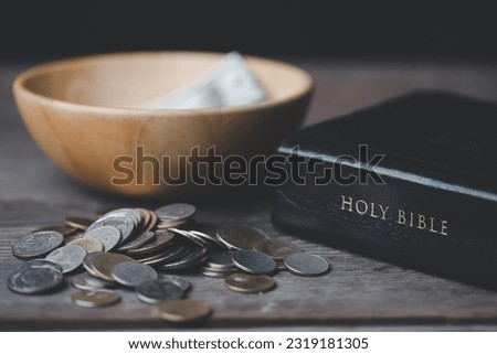 One tenth or tithe is basis on which Bible teaches us to donate one tenth of first fruit to God. Coins with Holy Bible. Religion donation and funding. Giving money, the symbol of Christianity donation