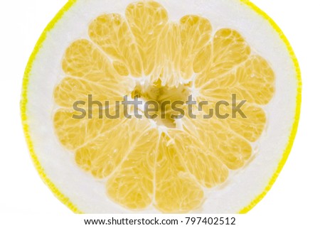 one thin slice of ripe grapefruit on a white background.