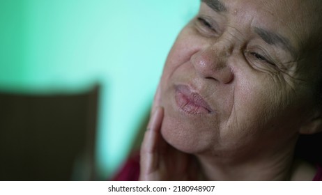 One Thoughtful Hispanic Older Woman Closeup Face. A Pensive South American Senior Lady