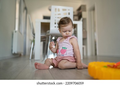 One Toddler Sitting On The Floor Eating And Looking Down Early Child Development Learning And Playing Concept