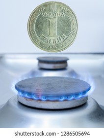 One Ukrainian Coin Hryvnia Over Gas Burner. Gas Import, Export Or Utility Costs In Europe Concept