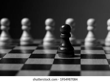 One Unique Pawn Outstanding From Many Opposits. Concept Of Individual, Different, Standout. Black And White.