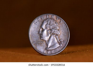 One US Quarter Coin On Orang Background. Macro.