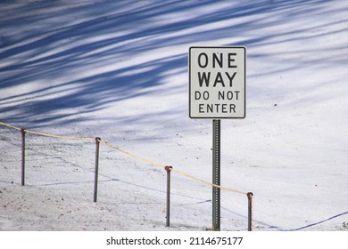 One Way Do Not Enter Sign Near A Snowy Road During The Winter.