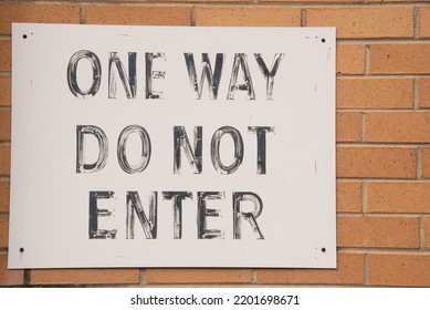 One Way Do Not Enter Sign On A Brick Wall. 