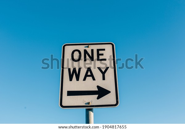 one way road sign\
with blue sky background