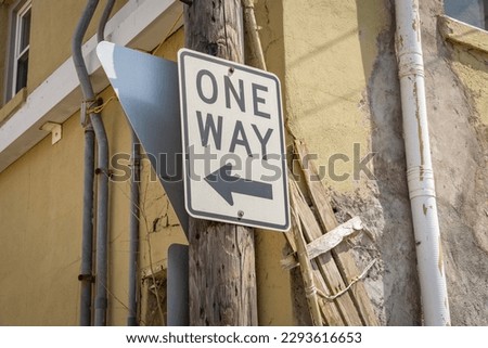 one way sign in an alley.