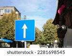 One Way Traffic sign near road with cars outdoors