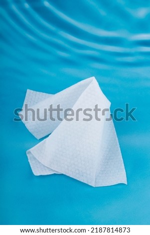 One wet wipe isolated on blue