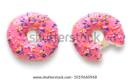 One whole and one with missing bite pink frosted donuts. Isolated on white background 
