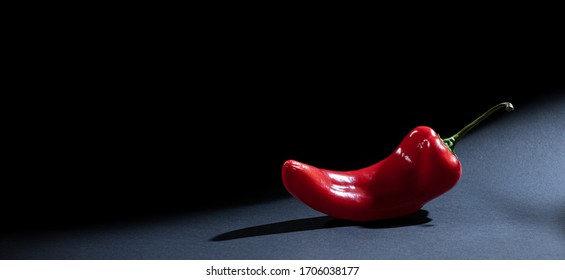 One Whole Red Sweet Bell Pepper (capsicum, Paprika, Cayenne, Chilli, Hot Chili, Jalapeno, сubanelle, Hungarian Wax Pepper) Isolated On Dark Gray, Black Background. Banner Or Panorama With Copy Space.