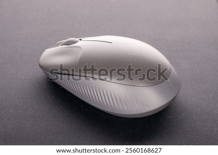 One wireless computer mouse on a computer mat, close-up, isolated on a white background.