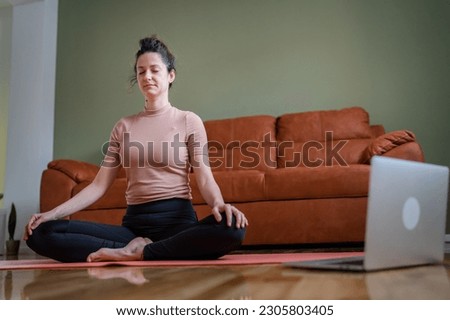 one woman adult caucasian female millennial practice online guided meditation use laptop for practicing mindfulness yoga with eyes closed on the floor at home real people self care concept copy space