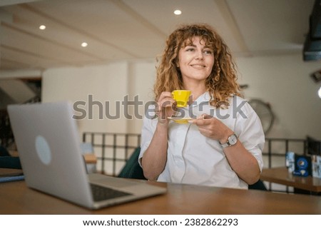 One woman adult caucasian female with curly hair smile having a cup of coffee at cafe carefree enjoy happy smiling copy space