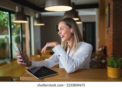 One woman adult middle age caucasian female standing at work happy smile confident wear white shirt waist up copy space front view portrait using mobile phone making a call or send sms confident - Shutterstock ID 2233839675