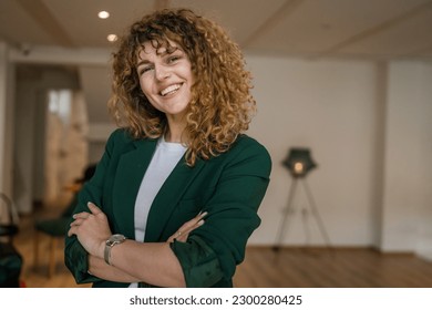 One woman caucasian female happy confident stand indoor at cafe with curly hair portrait smile real person copy space - Powered by Shutterstock