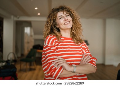 One woman caucasian female happy confident stand indoor at cafe with curly hair portrait smile real person copy space - Powered by Shutterstock