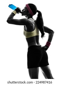 One Woman Exercising Fitness Drinking Energy Drink In Silhouette On White Background