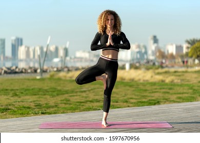 One Woman Exercising Tree Pose Yoga