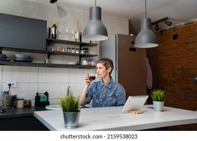 One Woman Mature Caucasian Female Having A Cup Of Coffee In The Kitchen While Using Digital Tablet Daily Morning Routine Checking Mail Or Daily Tasks While Preparing For Work Real People Copy Space