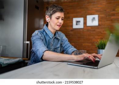 One Woman Mature Caucasian Female Working On Her Laptop Computer In The Kitchen At Home Freelance Remote Work Morning Routine Or Having Online Course Learning New Skill Real People Copy Space