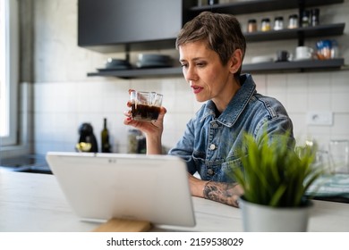 One Woman Mature Caucasian Female Having A Cup Of Coffee In The Kitchen While Using Digital Tablet Daily Morning Routine Checking Mail Or Daily Tasks While Preparing For Work Real People Copy Space