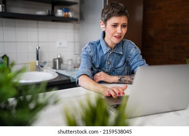 One Woman Mature Caucasian Female Working On Her Laptop Computer In The Kitchen At Home Freelance Remote Work Morning Routine Or Having Online Course Learning New Skill Real People Copy Space