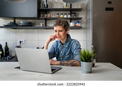 One Woman Mature Caucasian Female Working On Her Laptop Computer In The Kitchen At Home Freelance Remote Work Morning Routine Or Having Online Course Learning New Skill Real People Copy Space