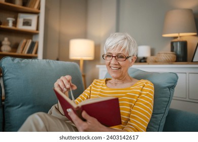 One woman mature senior caucasian female pensioner modern grandmother read book at home wear eyeglasses real person copy space - Powered by Shutterstock