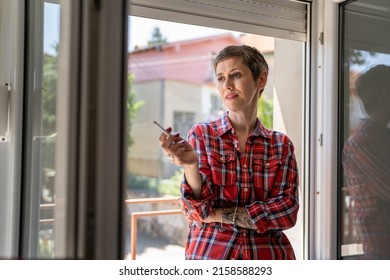 One Woman Mature Or Senior Female Smoking Cigarette By The Window At Home In Bright Day Real People Copy Space Daily Routine Unhealthy Habit Nicotine Addiction Smile Waiting