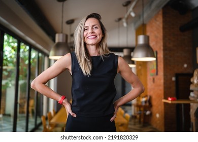 One Woman Middle Age Caucasian Female Standing At Home In Dining Room Or Restaurant Happy Smile Confident Wear Black Waist Up Copy Space Front View Portrait