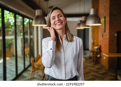 One Woman Middle Age Caucasian Female Standing At Home In Dining Room Or Restaurant Happy Smile Confident Wear White Shirt Waist Up Copy Space Front View Portrait