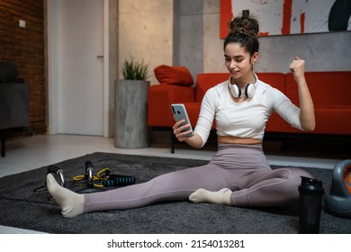 One Woman Young Adult Caucasian Female Sporty Holding Mobile Phone Using Internet For Online Training At Home Real People Sport Health And Fitness Concept Copy Space