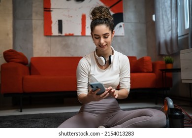 One Woman Young Adult Caucasian Female Sporty Holding Mobile Phone Using Internet For Online Training At Home Real People Sport Health And Fitness Concept Copy Space