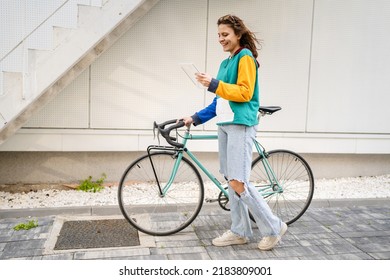 One Woman Young Adult Caucasian Female Walking By The University Building Holding Bicycle And Digital Tablet In Day Real People Copy Space Happy Smile Joyful Full Length Side View