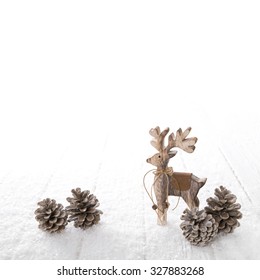 One Wooden Carved Reindeer Isolated On White Snowy Background For Christmas Decoration.