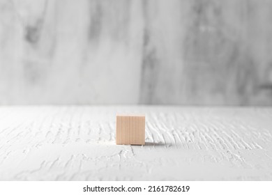 One Wooden Cube For Copy Space On An Empty Monochrome White Rustic Background With Gray Floor And Wall