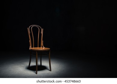 One Wooden Old Retro Chair In The Dark Room