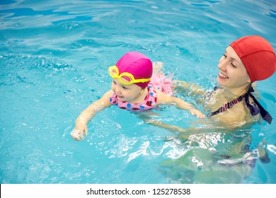 One Year  Baby Girl At His First Swimming Lesson With Mother