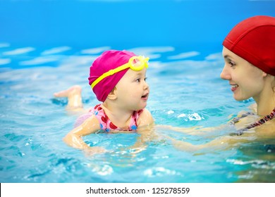 One Year  Baby Girl At His First Swimming Lesson With Mother