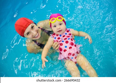 One Year  Baby Girl At His First Swimming Lesson With Mother