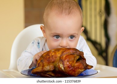 One Year Old Baby Boy Eating A Big Grilled Chicken