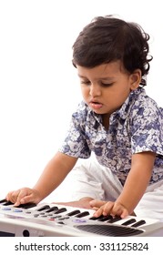 One Year Old Baby Boy Playing With Piano Toy Isolated On White Background Mumbai, Maharashtra, India, Southeast Asia.