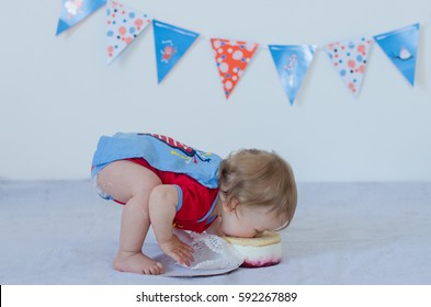 One year old baby eating cake