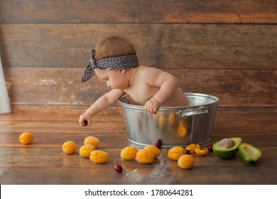 One Year Old Baby Girl Take A Bath With Fruits. Apricot In Summer Time. Happy Birthday Photo Concept. 