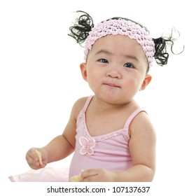 One Year Old Cute Pan Asian Baby Girl Eating On White Background