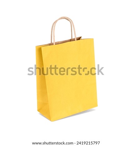 One yellow paper shopping bag isolated on white
