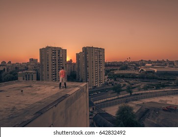 One Young Adult Man Only, Athlete Standing On Rooftop, Buildings Urban City Scene, Back Rear View, Sun Sunset Sunrise